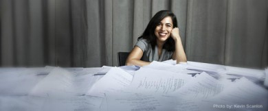 smiling woman-paper-covered table