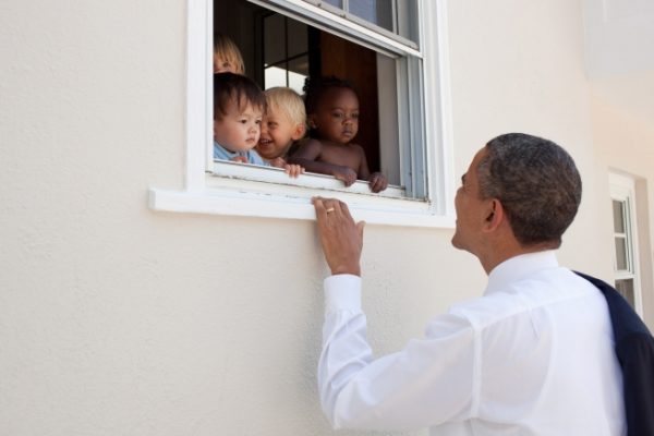 President Barack Obama greets children at a day care facility adjacent to daughter Sasha's school in Bethesda, Md., following her 4th grade closing ceremony, June 9, 2011.